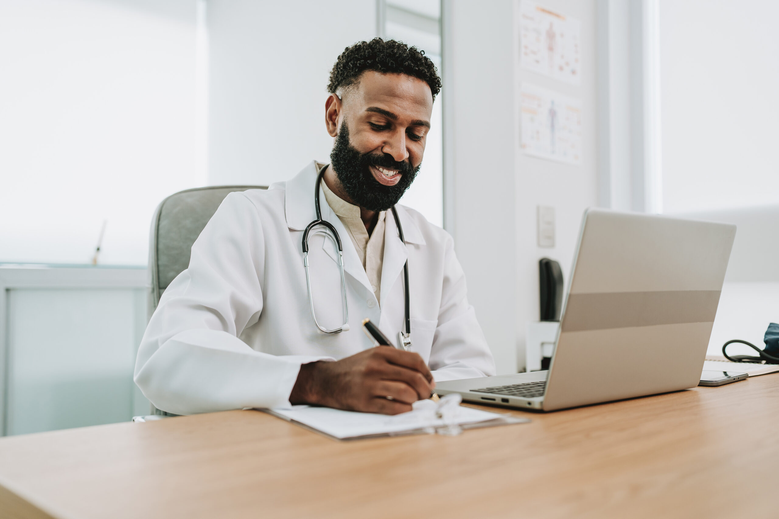Portrait of a doctor working on laptop at table